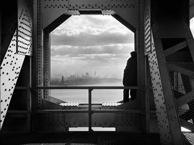 Dec. 22, 1936 of a man looking at the Hudson River from the New York tower of the George Washington Bridge 